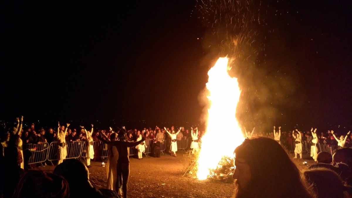 photo of neo-druids worshiping around a massive beltane bonfire